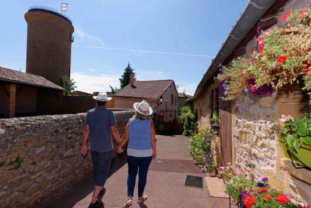 Deux personnes marchant dans le village d'Oingt, village de pierres dorées dans le Beaujolais (Rhône)